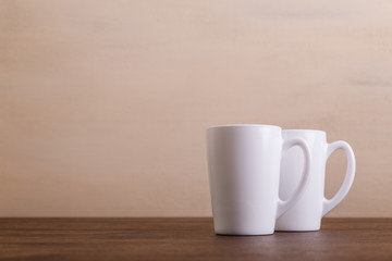 Obraz premium Mock-up mugs. Mockup coffee or tea cups. Design concept for branding. Front view. Wooden rustic board.