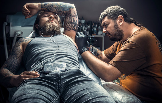 Tattooist makes tattoo pictures in studio