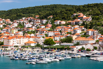 Fototapeta na wymiar Birds view of the bay of adriatic resort Shibenic. Yachts in harbor and red roofs of houses, of old mediterranean town.