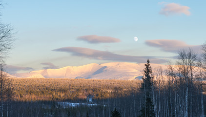 Winter panorama of the Khibiny (Hibiny) mountains with the moon.