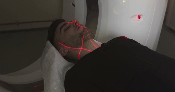 4K Man lays in Magnetic Resonance Image device, making tomographic scanning.
