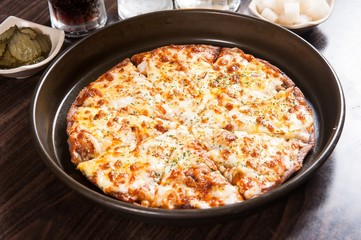 Cheese pizza on a wooden board