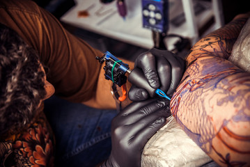 Tattoo artist makes tattoo pictures in studio