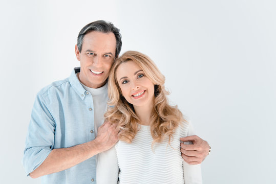 portrait of smiling stylish mature man and woman on white