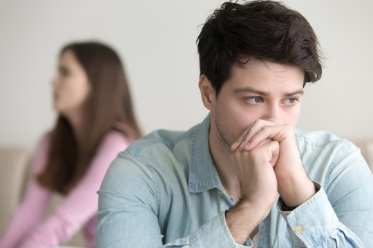 Sad young man thinking over a problem, guy frustrated after quarrelling with girlfriend, stressed and worried about financial issues, making decision and confused, bankruptcy, unpaid debt