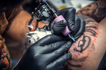 Fototapeta na wymiar Tattoo artist create tattoo in studio