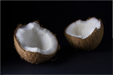 Ripe and appetizing coconut and its parts are isolated on a black background...