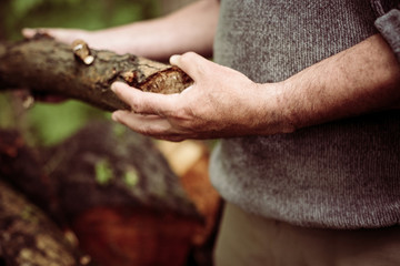 Man holding a tree trunk.