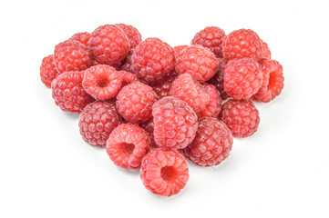 Heart shaped red raspberries isolated on white