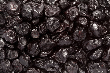 Organic air dried Blackcurrant (Ribes nigrum) berries. Macro close up background texture. Top view.