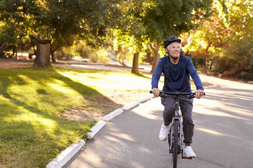 Naklejka premium Front View Of Senior Man Cycling Through Park