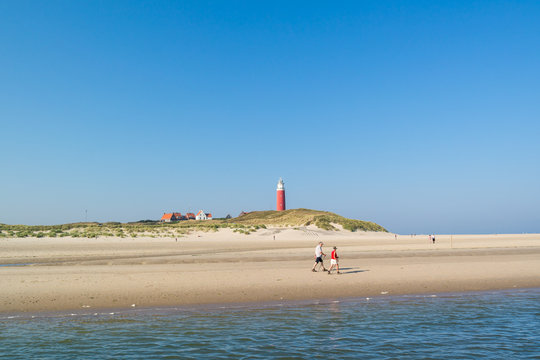Seniors walking on beach of Texel island, Netherlands