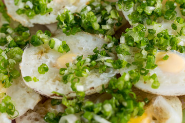 Dish from quail eggs sprinkled with green onion