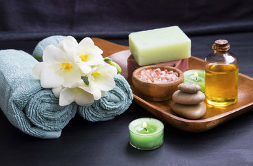 Obraz na płótnie Canvas Spa set treatments products with flower, towels, oil salt , soap and candles
