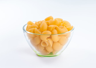 Handful of pipe rigate pasta in glass bowl