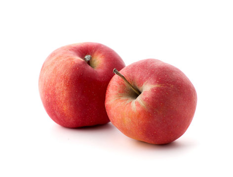 Two red ripe apples on a white background..