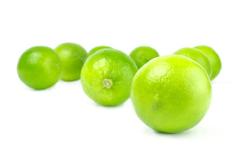 Scattered fresh limes isolated on white background cutout