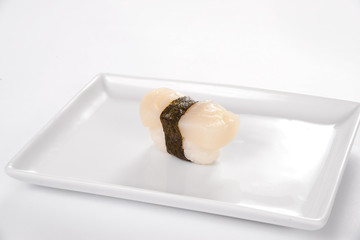 Sushi with smoked halibut on a white plate on a white background.