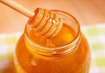 Honey on honeycomb background.