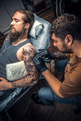 Fototapeta na wymiar Tattoo specialist posing in tattoo studio