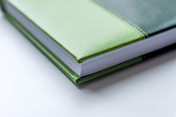 angle of green note book lying on the table