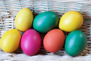 colorful easter eggs homemade in a straw basket