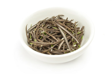 Dry leaves rosemary in plate isolated on white background cutout