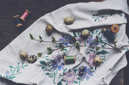 Vintage embroidery, wooden thread spools and quail eggs