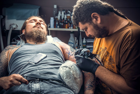 Tattooist works in studio
