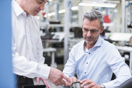 Two managers discussing product in company