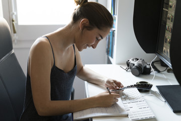 Female photographer editing images at desk