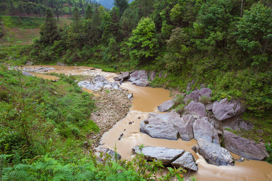 Mountain river in the forests on the way to  Fansipan mountain near the Sapa Village, Lao Cai, Vietnam.