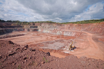 quarry mine of porphyry rock. driller in a mine