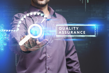 Business, Technology, Internet and network concept. Young businessman working on a virtual screen of the future and sees the inscription: Quality assurance