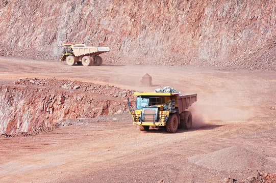 quarry mine of porphyry rock. dumper truck driving around