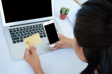 Woman with credit card and smart phone