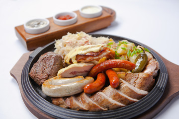 grilled sausages and potatoes on cooking pan