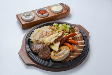 grilled sausages and potatoes on cooking pan
