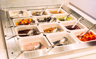 sweets for powdering  ice cream strawberry, nuts, chocolate biscuits, topping, kiwi fruit, jelly...