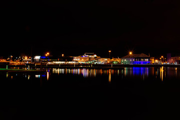 Fototapeta na wymiar Night fabulous landscape Stockholm harbor, illuminated buildings with reflection in water