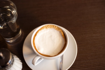 Cup of latte on wooden table