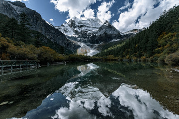Fototapeta na wymiar Mount Chenrizig and Pearl Lake in Daocheng,Sichuan,China. Mount Chenrizig is one of the three Tibetan holy mountians in Daocheng.