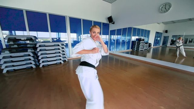 Young woman practicing the karate in the sport's gym