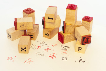 Wooden cubes stamps with letters printed on a white surface