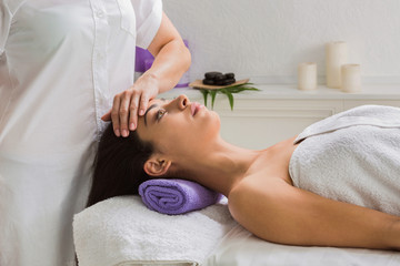 Woman beautician doctor make head massage in spa wellness center