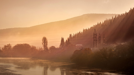 Sunrise in the foggy morning by the river