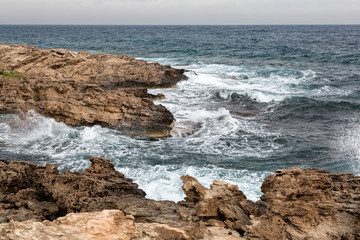 Fototapeta na wymiar Mediterranean Sea waves breaking rocky coastline of Cyprus island