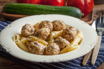 Pork meatballs with dill sauce and pasta. Selective focus.