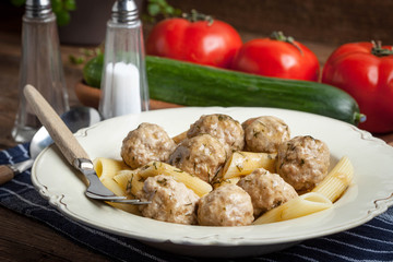Pork meatballs with dill sauce and pasta. Selective focus.