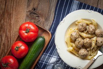 Pork meatballs with dill sauce and pasta. Selective focus.